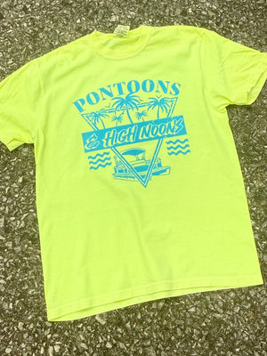 Front of neon yellow short sleeve T-shirt that has the text "Pontoons & High Noons" with a pontoon boat and palm trees in an 80s look printed in teal blue. The shirt is laying on the ground.