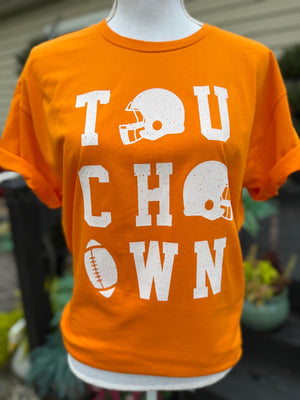 Orange t-shirt with white 'TOUCHDOWN' text and football graphics on a mannequin.