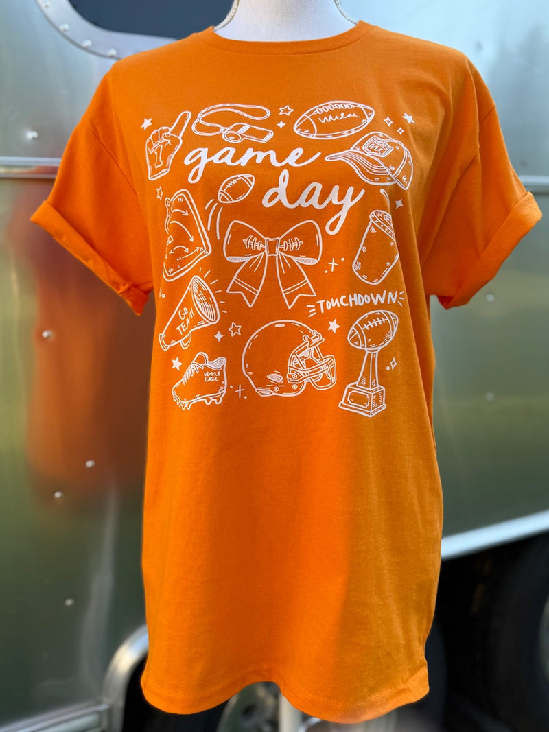 Orange t-shirt with 'game day' and sports-themed graphics in white on a mannequin.
